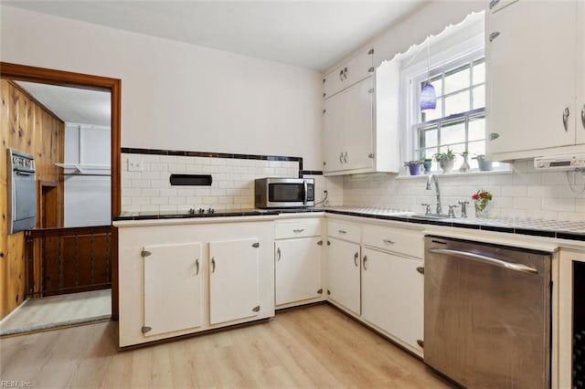 24 Holly Dr, Newport News, VA 23601 - kitchen with stainless steel appliances, light wood-style flooring, tile countertops, and white cabinetry