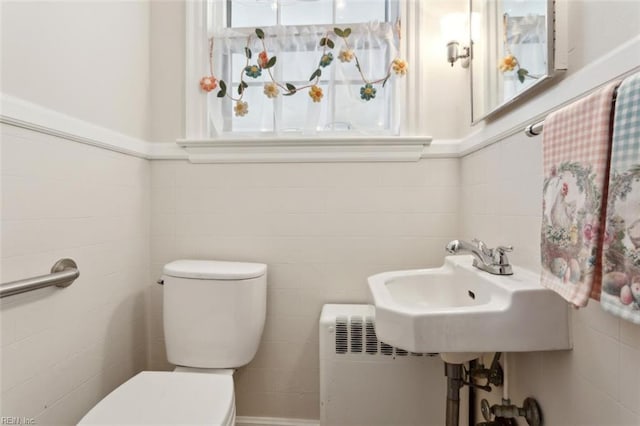 24 Holly Dr, Newport News, VA 23601 - half bath featuring tile walls, radiator heating unit, a sink, and toilet