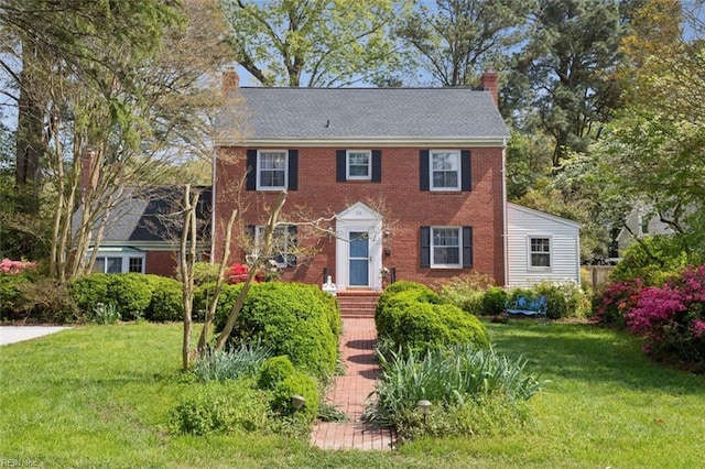 24 Holly Dr, Newport News, VA 23601 - colonial inspired home featuring a chimney, brick siding, and a front yard