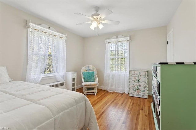 24 Holly Dr, Newport News, VA 23601 - bedroom with ceiling fan, baseboards, radiator heating unit, and light wood-type flooring
