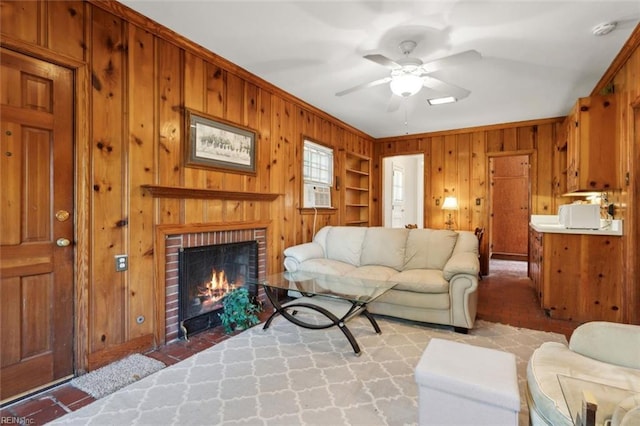 24 Holly Dr, Newport News, VA 23601 - living area with built in shelves, a ceiling fan, wooden walls, a fireplace, and ornamental molding