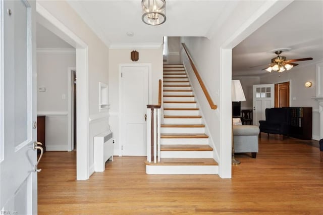 24 Holly Dr, Newport News, VA 23601 - entryway with radiator heating unit, crown molding, light wood-style flooring, stairs, and ceiling fan with notable chandelier