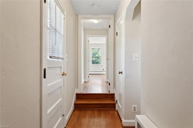 24 Holly Dr, Newport News, VA 23601 - corridor with baseboard heating, baseboards, a textured wall, and light wood-type flooring