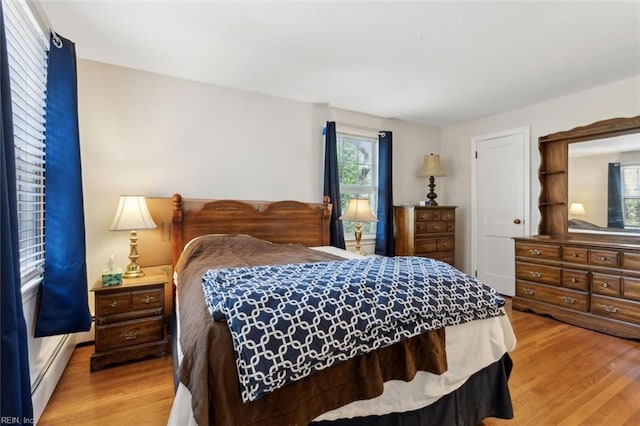 24 Holly Dr, Newport News, VA 23601 - bedroom featuring a baseboard heating unit and light wood-style flooring