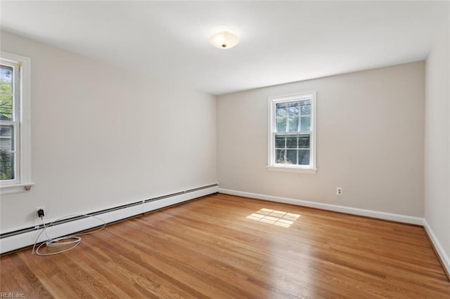 24 Holly Dr, Newport News, VA 23601 - spare room with baseboards, baseboard heating, wood finished floors, and a healthy amount of sunlight