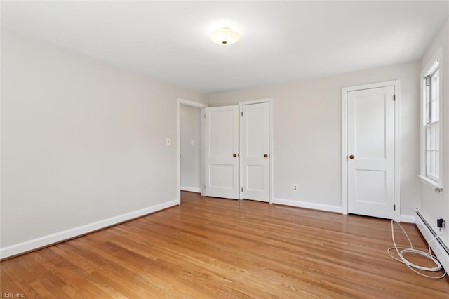 24 Holly Dr, Newport News, VA 23601 - unfurnished bedroom with a baseboard radiator, baseboards, and light wood-style floors
