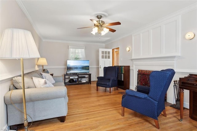 24 Holly Dr, Newport News, VA 23601 - living area featuring light wood-type flooring, ornamental molding, a fireplace, and ceiling fan