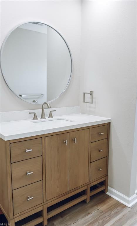 404 Hogart St, Franklin, VA 23851 - bathroom with baseboards, vanity, and wood finished floors