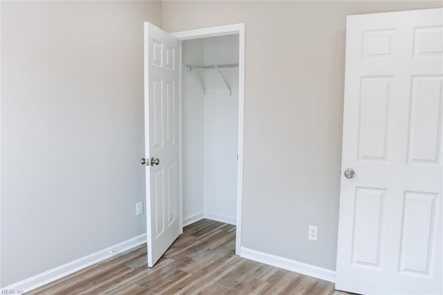 404 Hogart St, Franklin, VA 23851 - unfurnished bedroom featuring wood finished floors, a closet, and baseboards