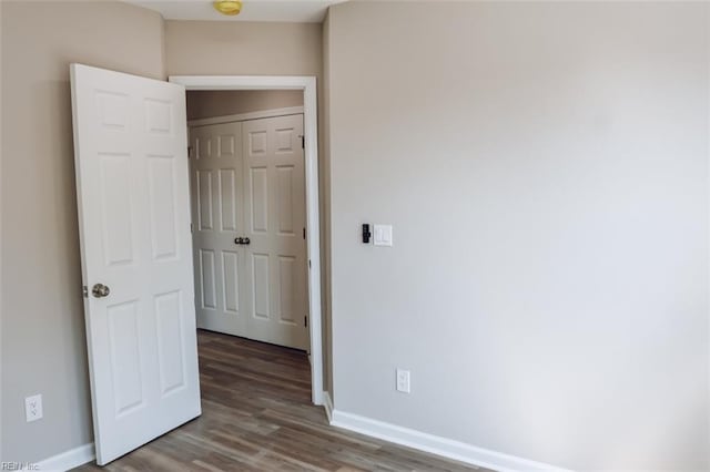 404 Hogart St, Franklin, VA 23851 - unfurnished bedroom featuring baseboards and wood finished floors