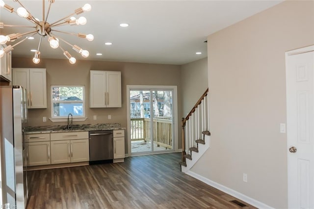 404 Hogart St, Franklin, VA 23851 - kitchen with dark wood finished floors, appliances with stainless steel finishes, a sink, and a healthy amount of sunlight