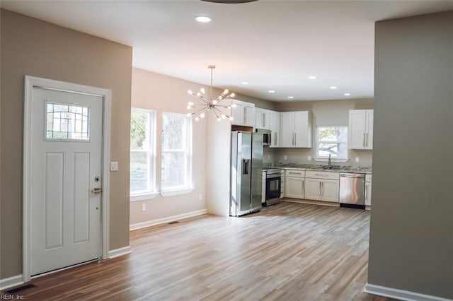 404 Hogart St, Franklin, VA 23851 - kitchen with an inviting chandelier, appliances with stainless steel finishes, a sink, and light wood-type flooring