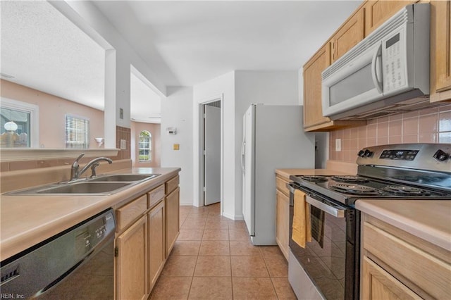 5201 Bardith Cir, Virginia Beach, VA 23455 - kitchen featuring stainless steel range with electric stovetop, white microwave, black dishwasher, a sink, and decorative backsplash