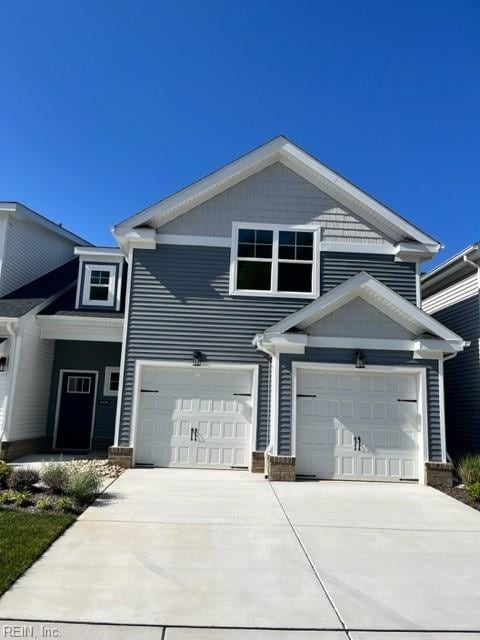 view of front of property with concrete driveway and an attached garage