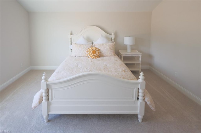 bedroom featuring baseboards and light carpet