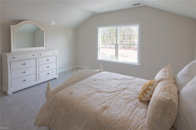bedroom with vaulted ceiling, carpet flooring, visible vents, and baseboards