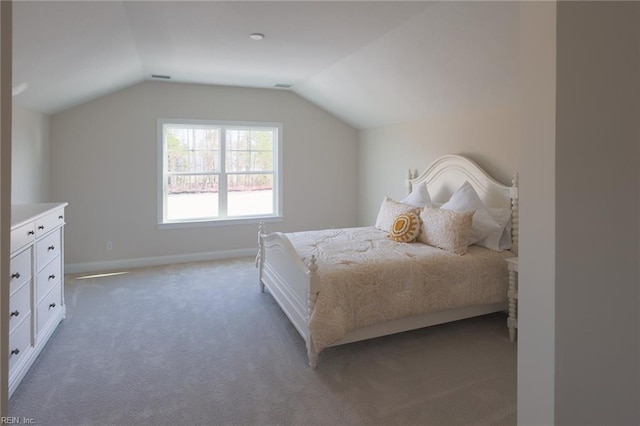 bedroom with light colored carpet, vaulted ceiling, visible vents, and baseboards