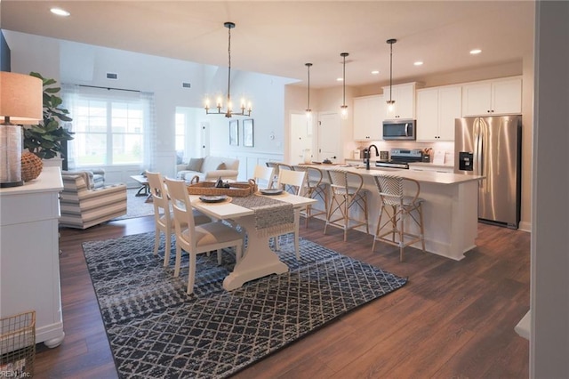 dining room featuring an inviting chandelier, dark wood-style flooring, visible vents, and recessed lighting