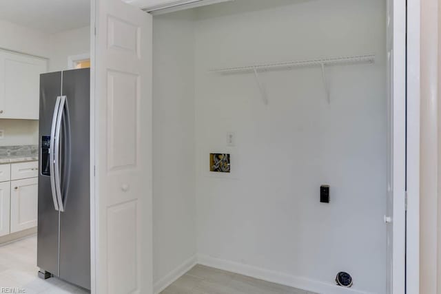 laundry area with baseboards and hookup for a washing machine
