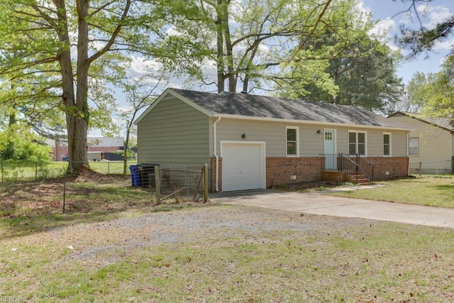 exterior space featuring an attached garage, concrete driveway, and fence