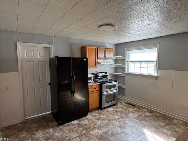 3800 Victoria Blvd, Hampton, VA 23669 - kitchen with brown cabinetry, under cabinet range hood, double oven range, and black fridge