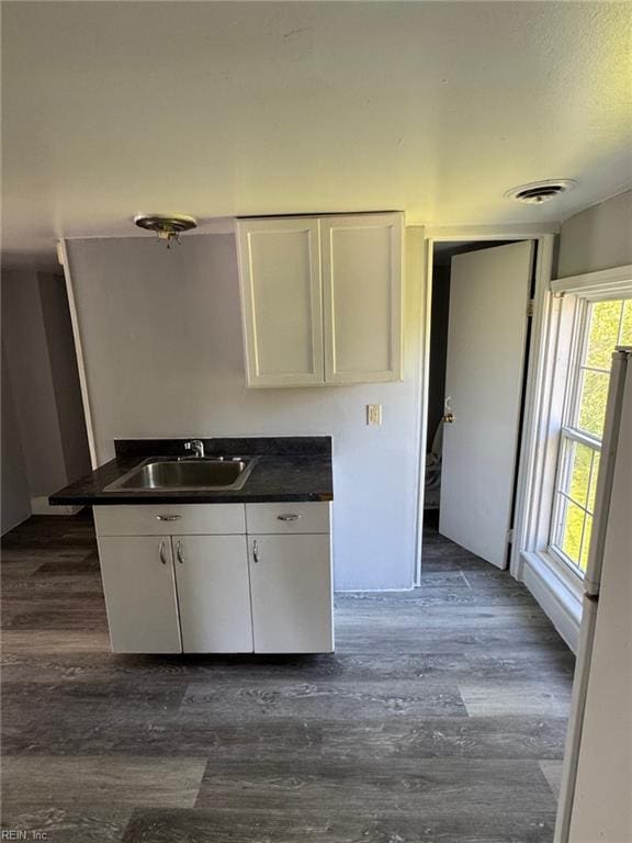 3800 Victoria Blvd, Hampton, VA 23669 - kitchen featuring white cabinets, dark countertops, visible vents, and a sink