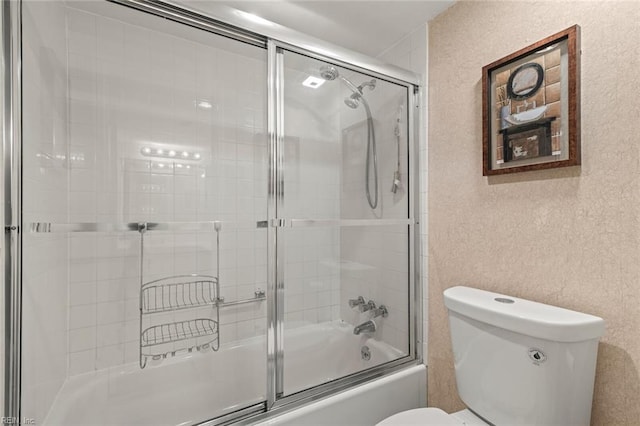 3300 Ocean Shore Ave Unit 503, Virginia Beach, VA 23451 - bathroom featuring shower / bath combination with glass door, a textured wall, and toilet