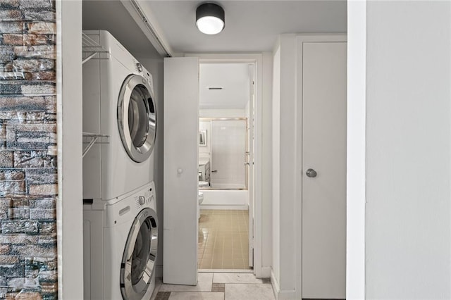 3300 Ocean Shore Ave Unit 503, Virginia Beach, VA 23451 - laundry area featuring stacked washer and dryer, light tile patterned floors, and laundry area