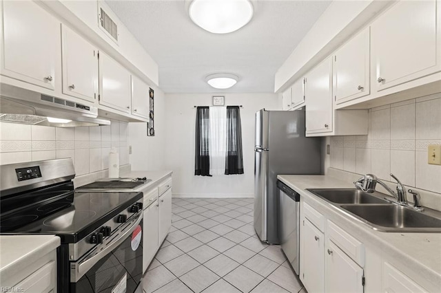 3300 Ocean Shore Ave Unit 503, Virginia Beach, VA 23451 - kitchen with under cabinet range hood, visible vents, a sink, decorative backsplash, and appliances with stainless steel finishes