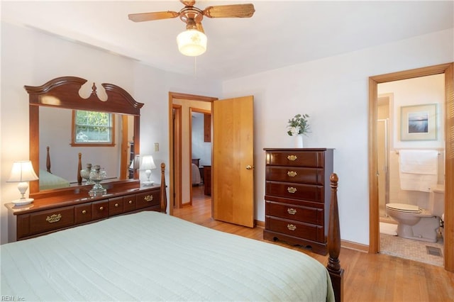 bedroom featuring light wood-type flooring, ensuite bathroom, baseboards, and a ceiling fan