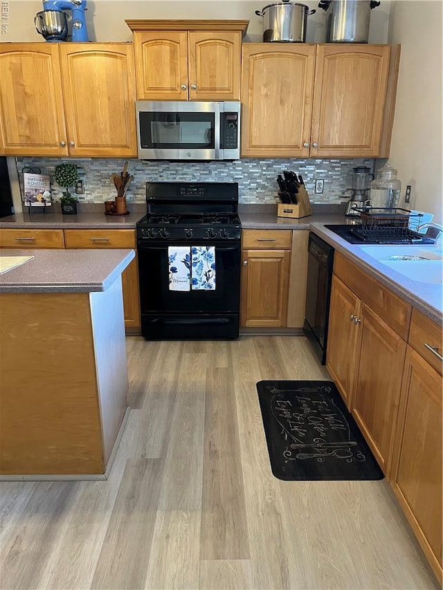 2064 Nicklaus Dr, Suffolk, VA 23435 - kitchen featuring tasteful backsplash, light wood-type flooring, and black appliances