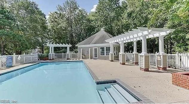 2064 Nicklaus Dr, Suffolk, VA 23435 - pool featuring fence, an outdoor structure, a pergola, and a patio