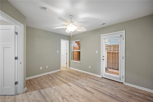 spare room featuring visible vents, baseboards, light wood-style floors, and ceiling fan