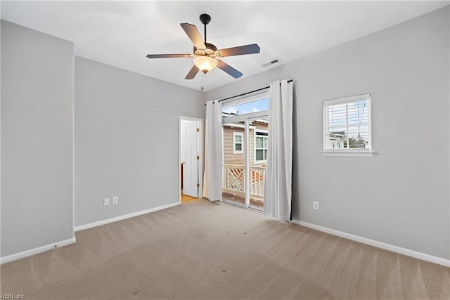 spare room with ceiling fan, baseboards, and carpet flooring
