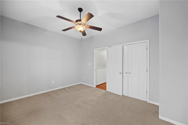 unfurnished bedroom featuring baseboards, carpet, a closet, and ceiling fan