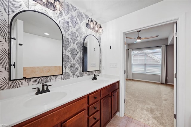 bathroom with wallpapered walls, a ceiling fan, a sink, and double vanity