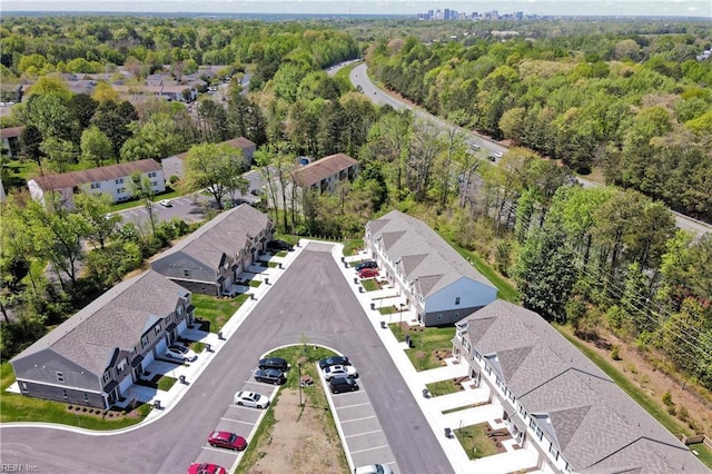 birds eye view of property with a forest view and a residential view