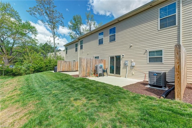 back of house with a yard, a patio, central AC unit, and fence