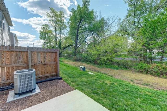 view of yard with fence and cooling unit