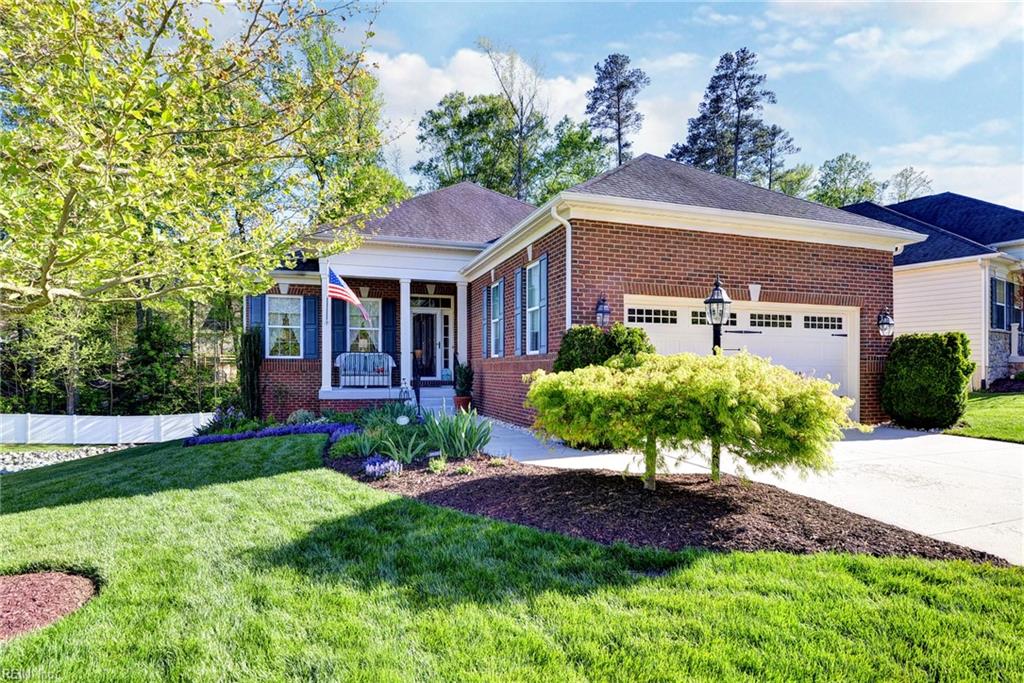 3971 Lord Dunmore Dr, Williamsburg, VA 23188 - view of front of home with brick siding, driveway, a front yard, and a garage