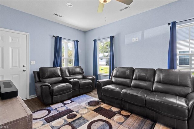 living room featuring ceiling fan, wood finished floors, and visible vents