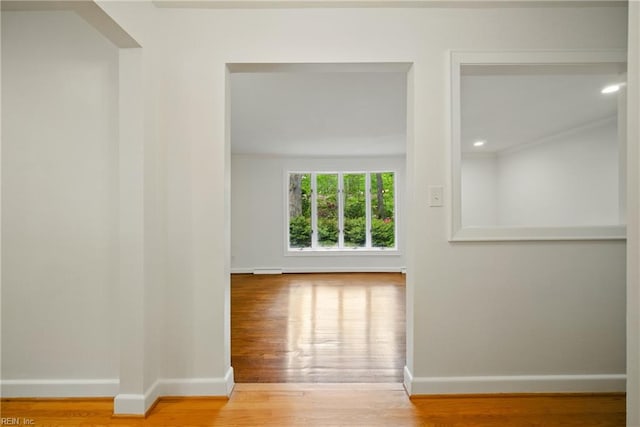 spare room featuring recessed lighting, wood finished floors, and baseboards