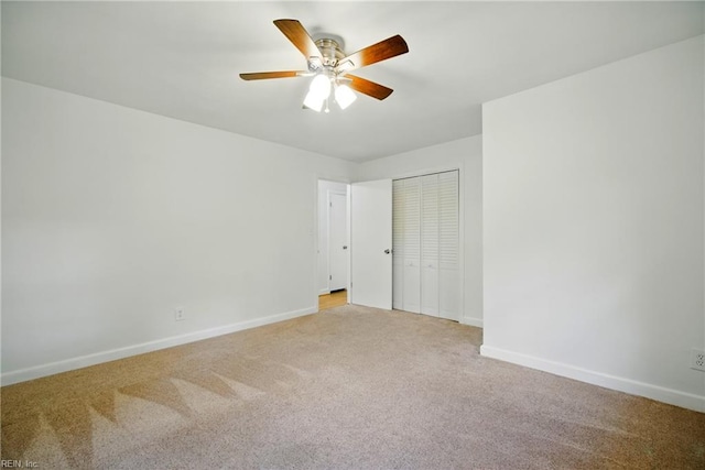 empty room with baseboards, light colored carpet, and ceiling fan