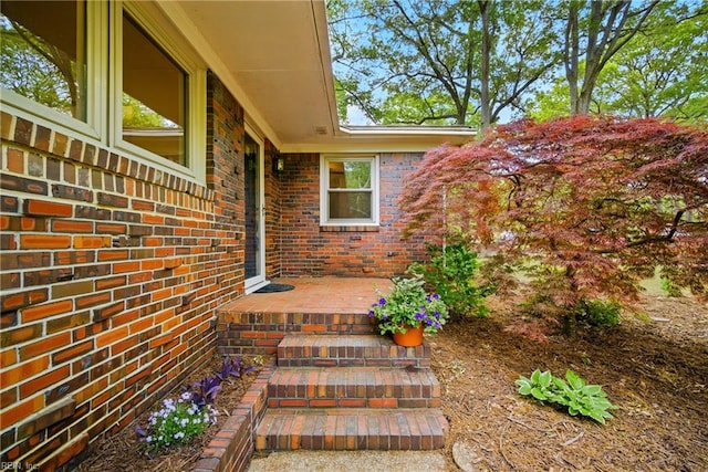 entrance to property with brick siding