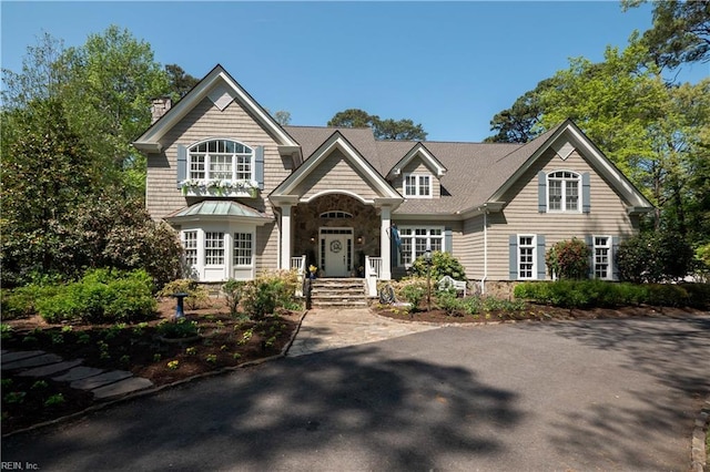 view of front of home featuring a chimney