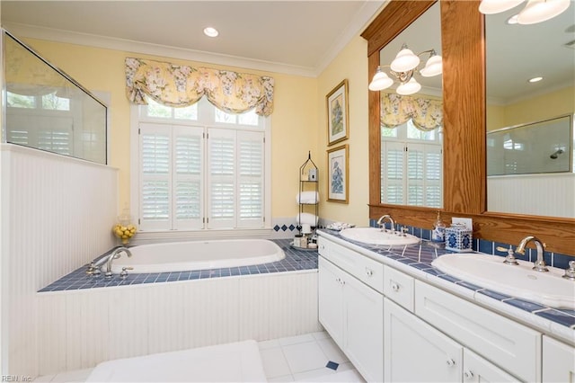 bathroom with a wealth of natural light, ornamental molding, and a sink