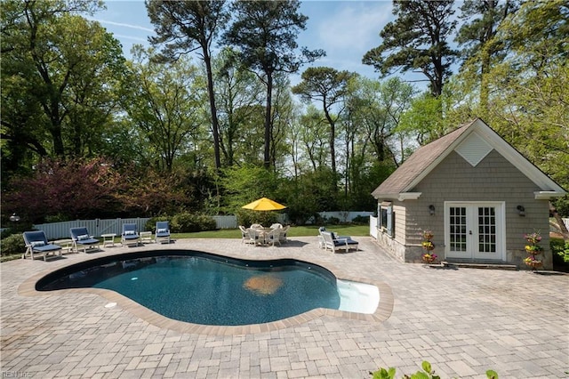 view of swimming pool featuring fence private yard, a patio, a fenced in pool, and french doors