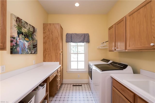 clothes washing area featuring washing machine and clothes dryer, baseboards, recessed lighting, cabinet space, and light floors