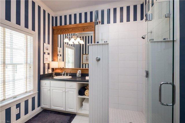 full bathroom with wallpapered walls, a stall shower, vanity, a chandelier, and tile patterned flooring