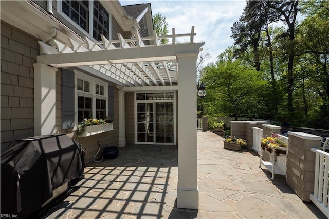view of patio / terrace with fence, a pergola, and a grill